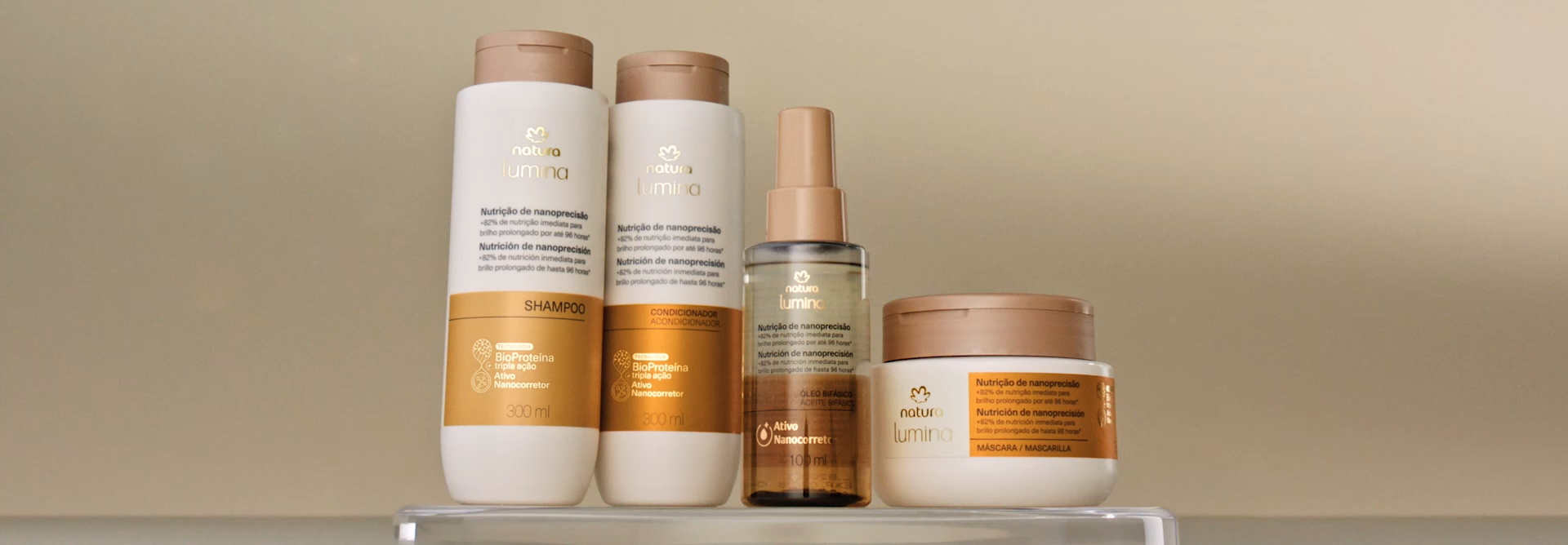 4 produtos de Lumina Nutrição de Nanoprecisão entram em foco e corta para Simulação ilustrada de como a linha Lumina Nutrição de Nanoprecisão age no cabelo, encerrando com uma mulher branca de cabelos escuros posando para fotos.