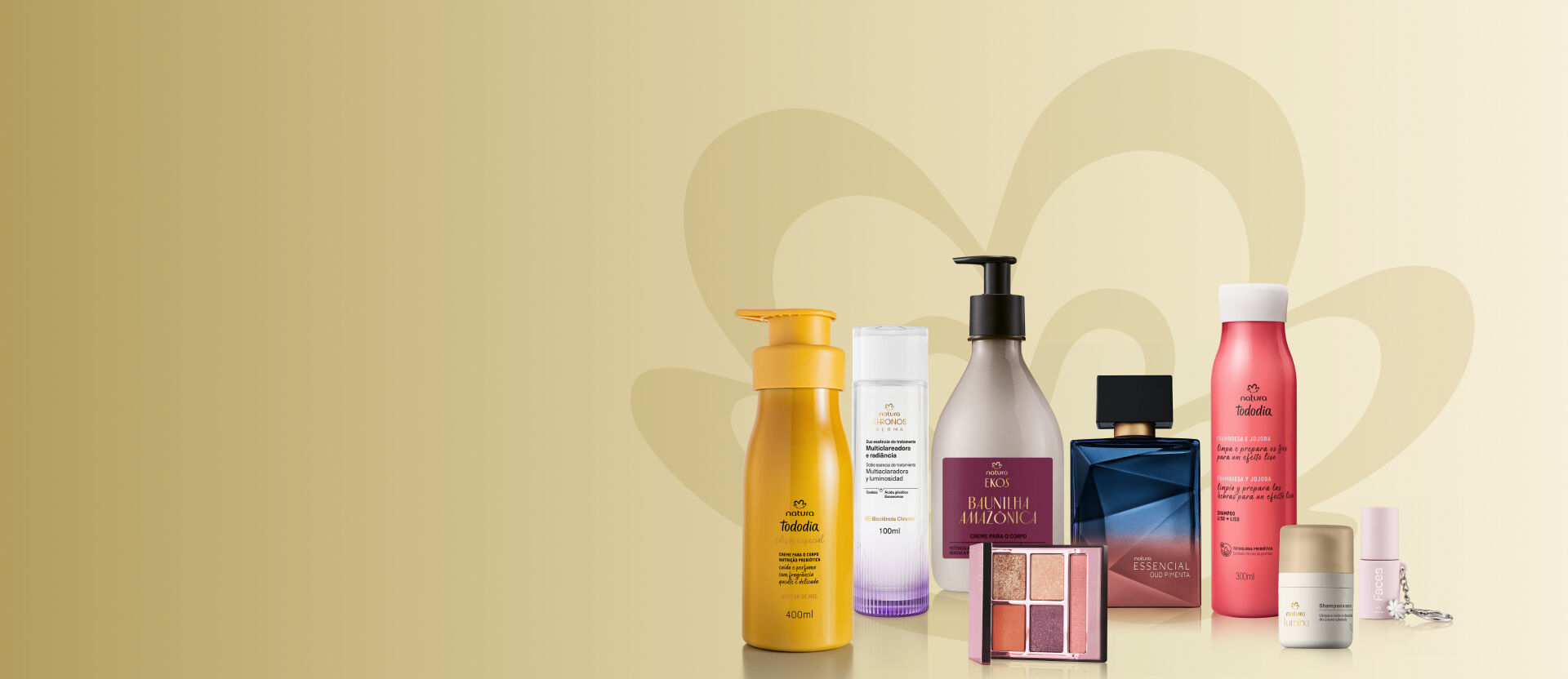 Produtos Natura em fundo cinza. Entre eles estão hidratantes Tododia e Ekos, Duo Essência Chronos, fragrância Essencial, shampoo, paleta de maquiagem e batom Faces.