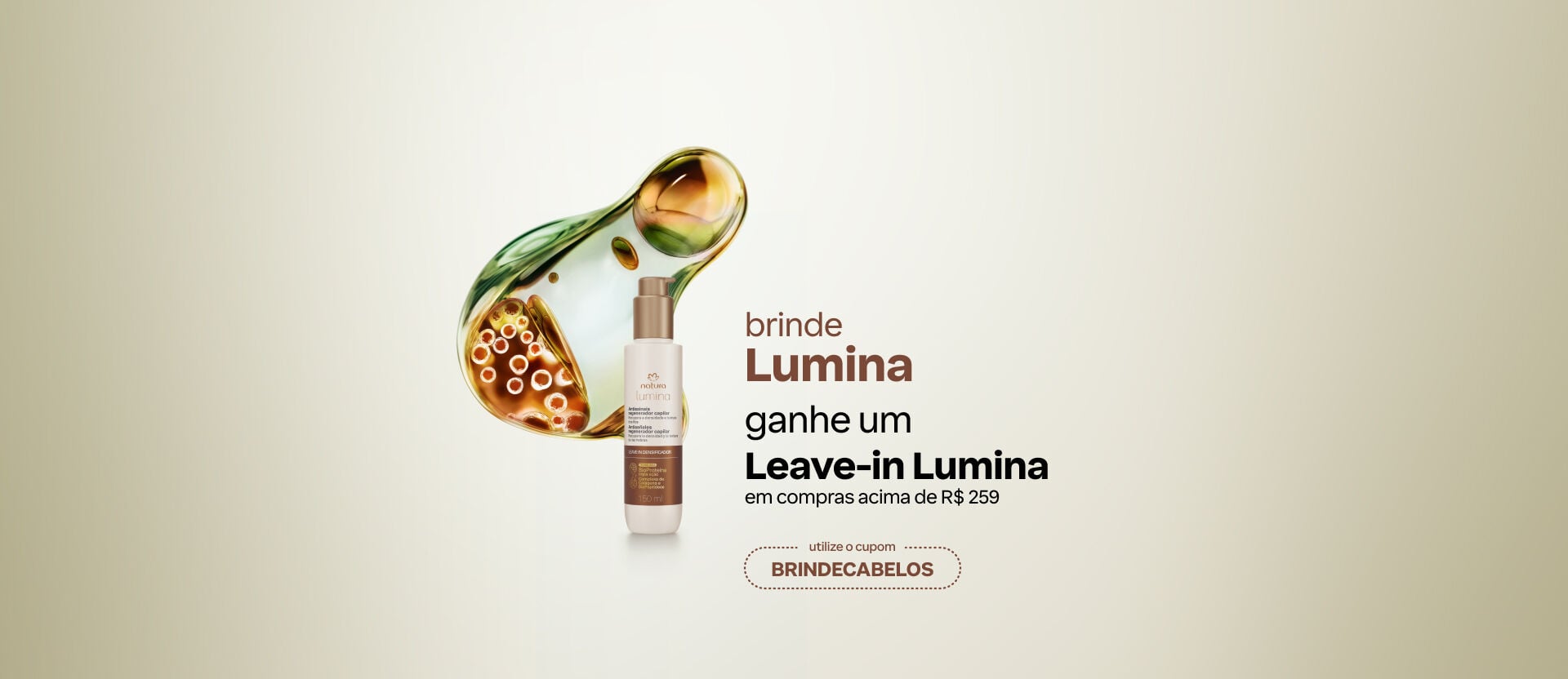 Frasco do Natura Lumina diante de gota d'água fluida em fundo verde-claro. Texto: "brinde Lumina: ganhe um Leave-in Lumina em compras acima de R$259. use o cupom BRINDECABELOS". 