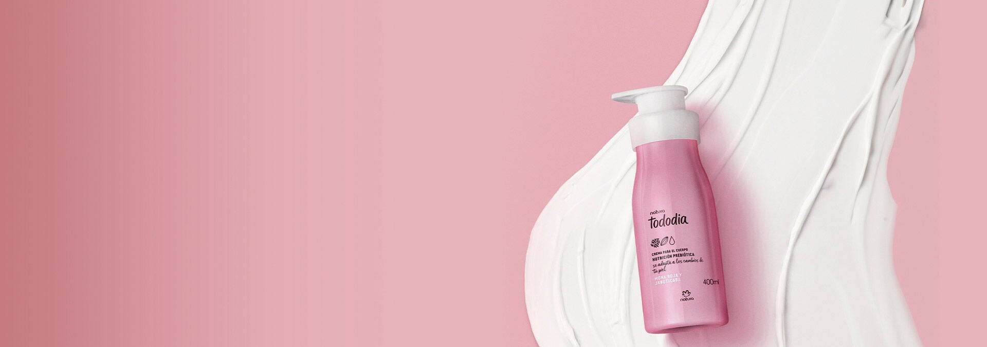 Fondo rosa con una crema hidratante corporal Tododia a la derecha, con la textura del producto detrás.