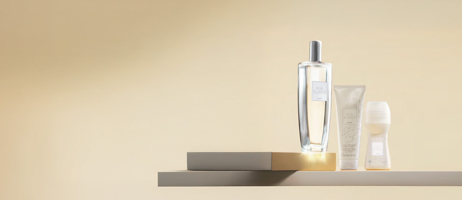 Frasco de fragrância Pur Blanca com bisnaga de Loção Perfumada para o Corpo e embalagem de Desodorante Roll-on sobre placas cinza, em fundo em tom creme.