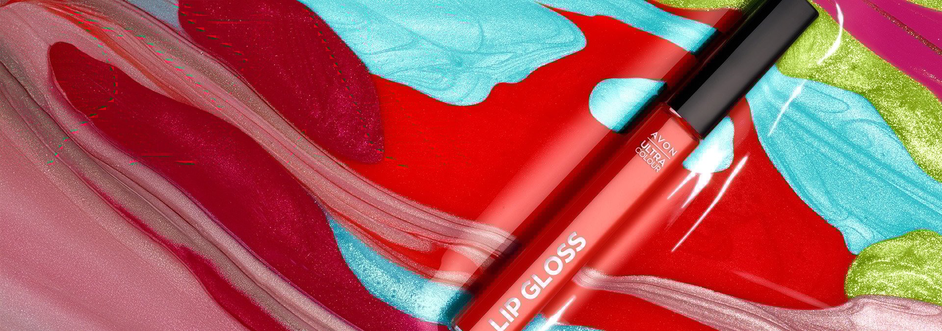 Banner com fundo vibrante em tons de vermelho, azul e verde, apresentando o gloss labial Avon Ultra Colour. O texto sugere lábios brilhantes e hidratados para arrasar todos os dias.