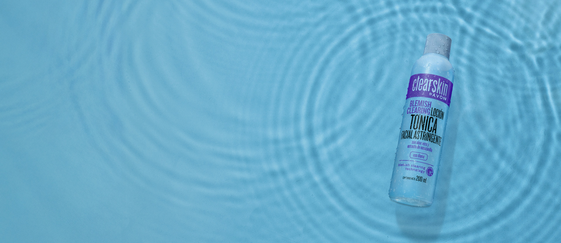 Banner con fondo azul y efectos de agua. Se presenta una loción astringente ClearSkin. Texto: "Loción astringente 3 x $199.99. Lo que tu piel necesita para eliminar las imperfecciones".
