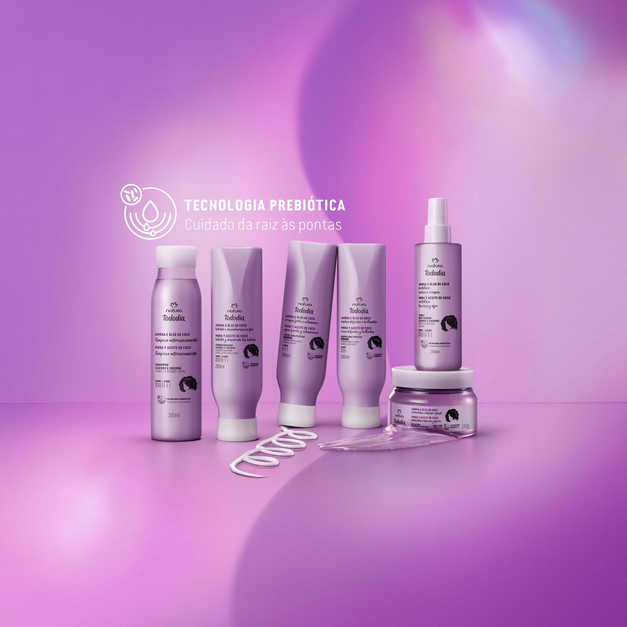 Linha Tododia Amora e Óleo de Coco, incluindo shampoo, condicionador, cremes para pentear, spray e gelatina. Embalagens lilás com tampas brancas. Selo Técnologia Prebiótica cuidado da raiz às pontas. 