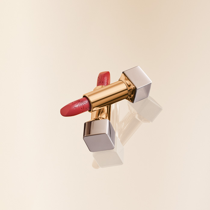 Duas embalagens abertas de tons rosados de Batom Natura Una Celebrar em fundo amarelo-claro.