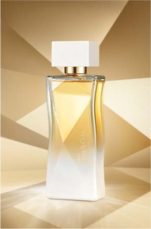 Frasco de Essencial Exclusivo Floral Feminino, em tons de branco e dourado, aparece em destaque no centro da tela sobre fundo multifacetado dourado, fazendo alusão ao design do frasco de Essencial.