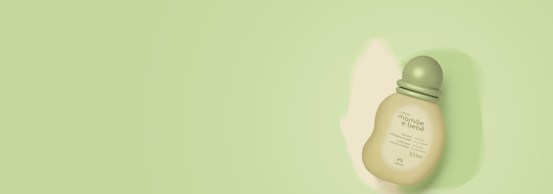 Fundo em tons de verde e ao lado direito o óleo para massagem Natura Mamãe e Bebê