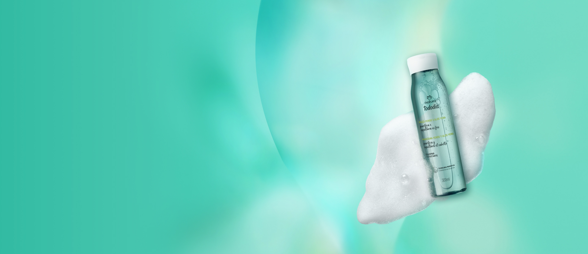 Hidratante Tododia Maçã Verde e Aloe Vera com textura de espumas ao redor do frasco sobre fundo azul.