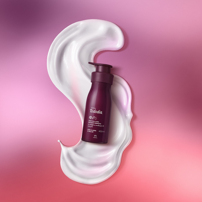 Produto Natura Tododia sobre textura branca em fundo em tons de vermelho.
