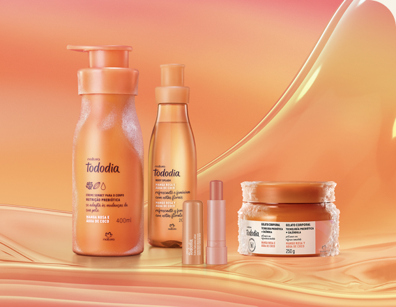 Itens Tododia Manga Rosa e Água de Coco, em laranja: frasco de Creme Sorbet, frasco de Body Splash, embalagem aberta de Balm Labial e pote de Gelato Corporal sobre grafismo e fundo em laranja.
