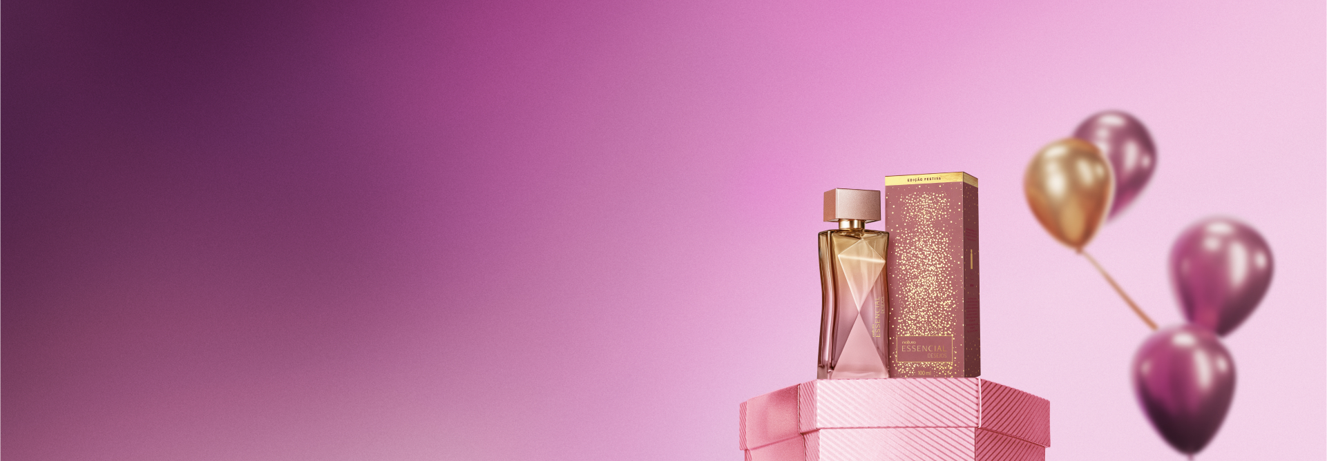 Deo Parfum Essencial Desejos Feminino, frasco retangular rosa e dourado ao lado de embalagem nas mesmas cores, sobre caixa de presente rosa. Fundo rosa com balões em rosa e dourado.