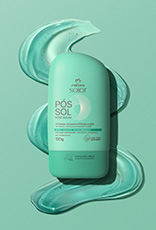 Embalagens Natura Solar Facial FPS 50 creme e verde, Corporal FPS 50 laranja e Pós-Sol verde, sobre grafismo semi-circular em laranja e creme. À direita, selo Tecnologia Bioproteção sobre foto de textura cremosa sobre ombro feminino.