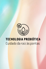 Selo Tecnologia Prebiótica Cuidado da raiz às pontas em fundo nas cores verde, amarelo e rosa.