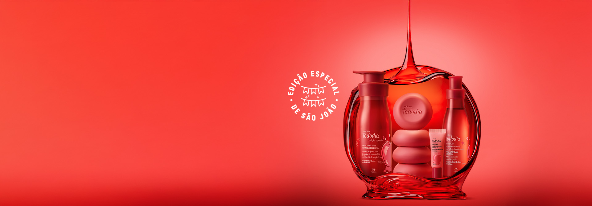 Linha Natura Tododia sobre forma vermelha em fundo com tons de vermelho e selo Edição Especial de São João