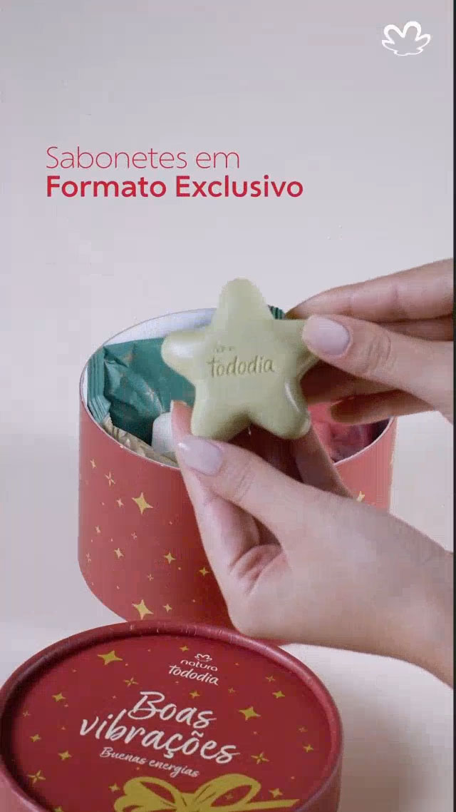 Tela laranja com logo da Natura e texto: Descubra Tododia Estrelas! Pessoa abrindo a caixa redonda e vermelha e mostrando os sabonetes em formato de estrela nas cores verde, branco e rosa, bem como as embalagens individuais com mensagens inspiradoras de Natal. O vídeo destaca a caixa reutilizável e altamente presenteável. Tela final laranja com o texto: Gostou? Compartilhe. 