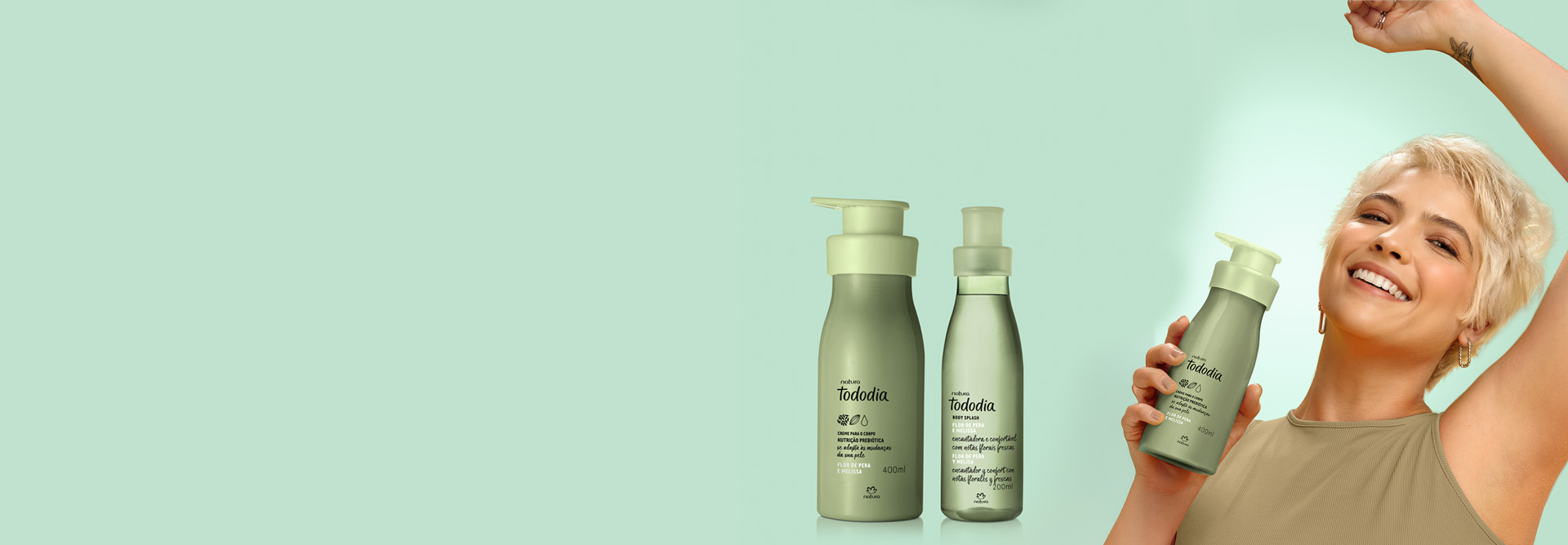 Creme Hidratante Corporal e Body Splash Tododia Flor de Pera e Melissa aparecem em destaque no centro da tela sobre fundo verde-claro. Ao lado, modelo branca segura o Hidratante Corporal e sorri.