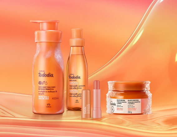 Itens Tododia Manga Rosa e Água de Coco, em laranja: frasco de Creme Sorbet, frasco de Body Splash, embalagem aberta de Balm Labial e pote de Gelato Corporal sobre grafismo e fundo em laranja.