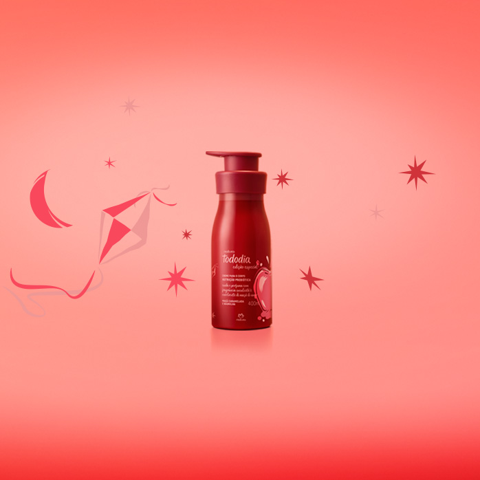 Hidratante Corporal Natura Tododia em fundo em tons de vermelho com ilustrações de estrelas, lua e balão junino.