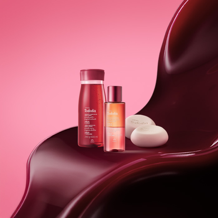 Produtos Natura Tododia Cereja e Avelã sobre formas orgânicas na cor vermelha, em fundo rosa.