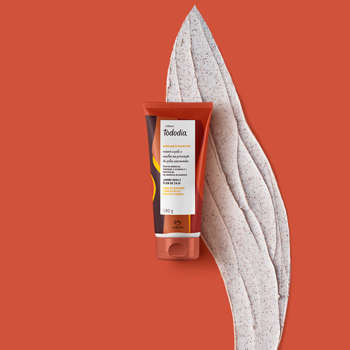 Esfoliante Tododia Jambo Rosa e Flor de Caju em destaque no centro da tela sobre fundo laranja. Ao lado, textura do produto.