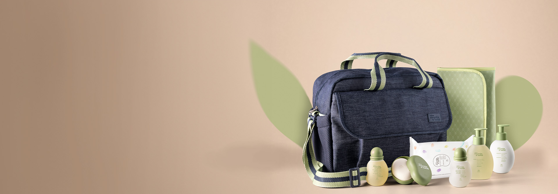 À direita, produtos Natura Mamãe e Bebê com bolsa e trocador em fundo em tom creme.