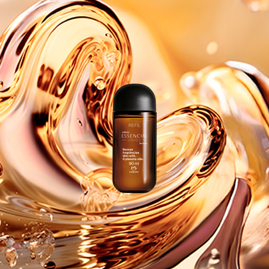Refil Essencial Único Feminino, com embalagem de vidro âmbar e tampa preta, destaca-se no centro da tela. Ao fundo, texturas aquosas em tom de âmbar formam a flor símbolo da Natura.