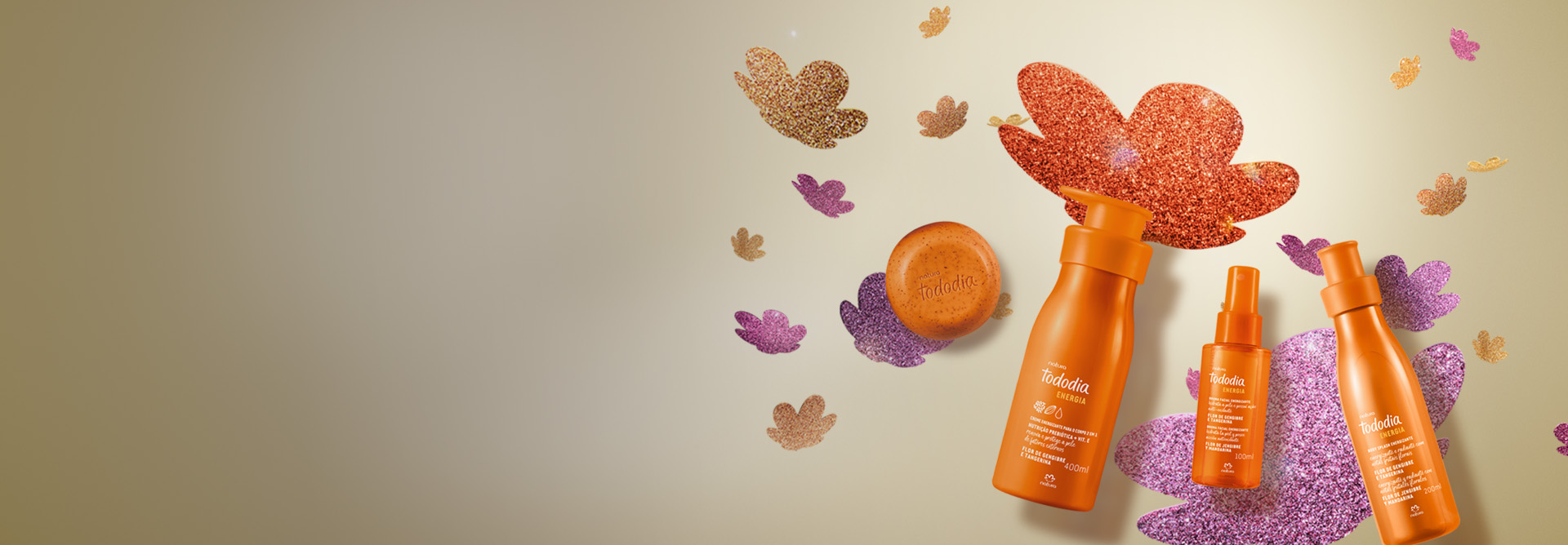 4 produtos Tododia Flor de Gengibre e Tangerina em embalagens laranja: 1 sabonete, 1 creme, uma bruma e 1 body splash. Fundo claro com a flor símbolo da Natura aplicada em diferentes cores de glitter. 