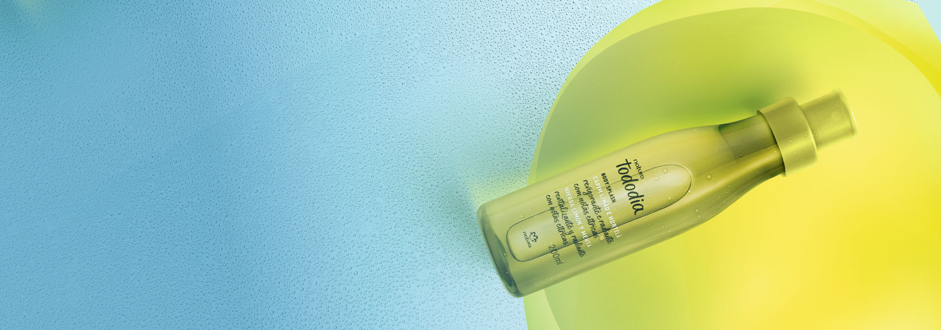 Body Splash Natura Tododia Capim Limão e Hortelã sobre um fundo verde-água texturizado e com detalhes em amarelo vibrante.
