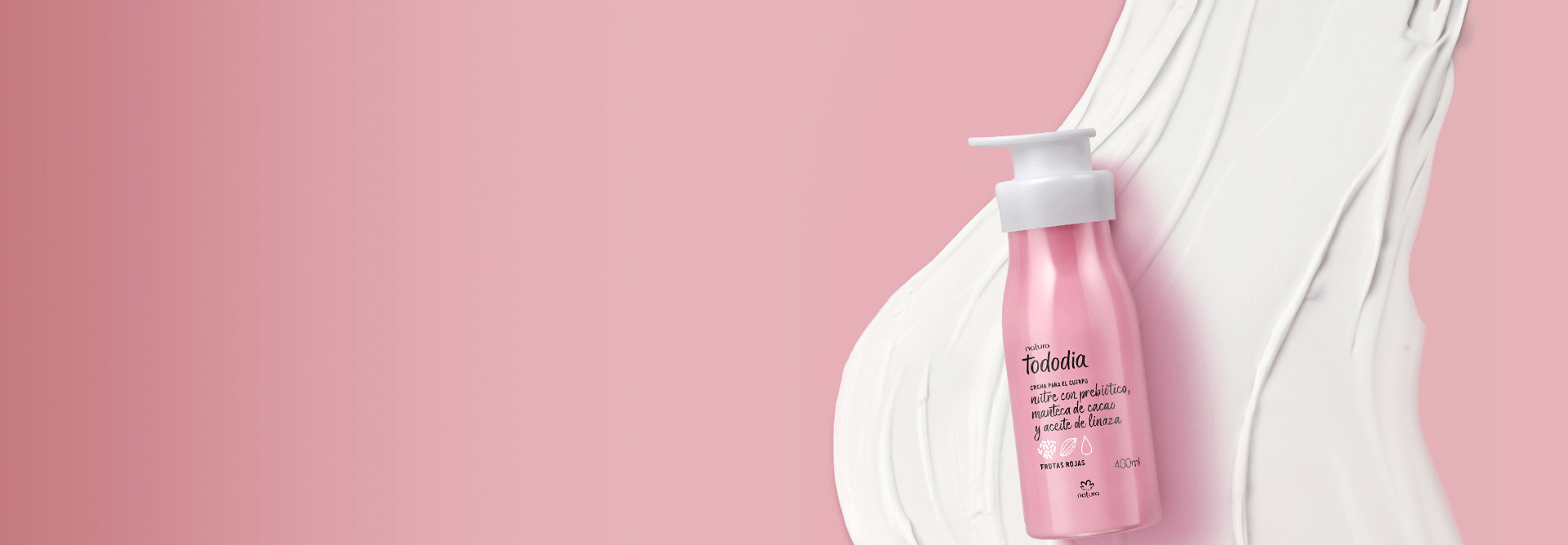 Fondo rosa con una crema hidratante corporal Tododia a la derecha, con la textura del producto detrás.