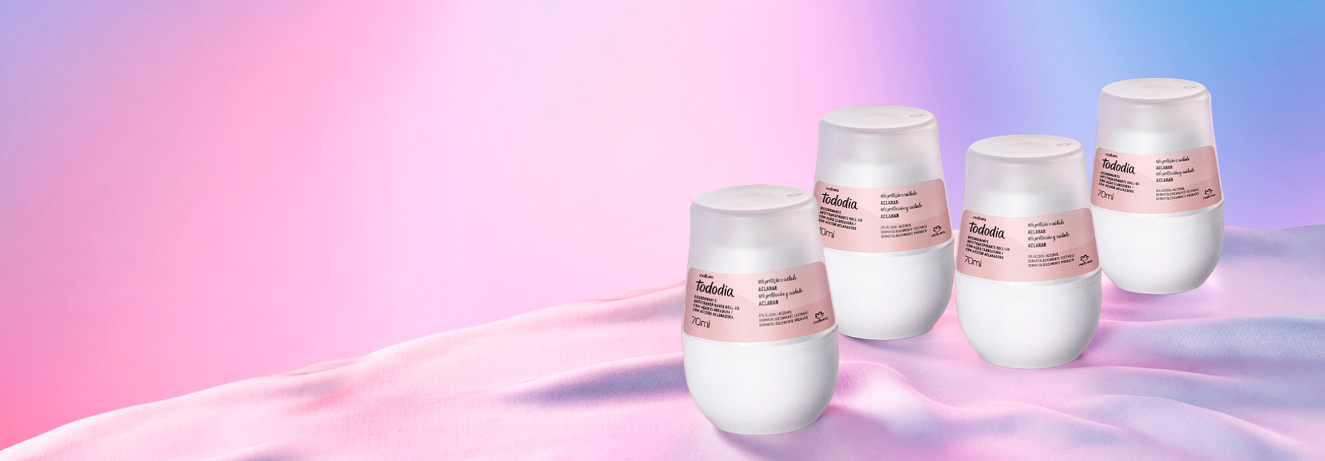 Imagen con fondo claro en tonos rosa, morado y azul y a la derecha algunos desodorantes roll on de Natura Tododia.