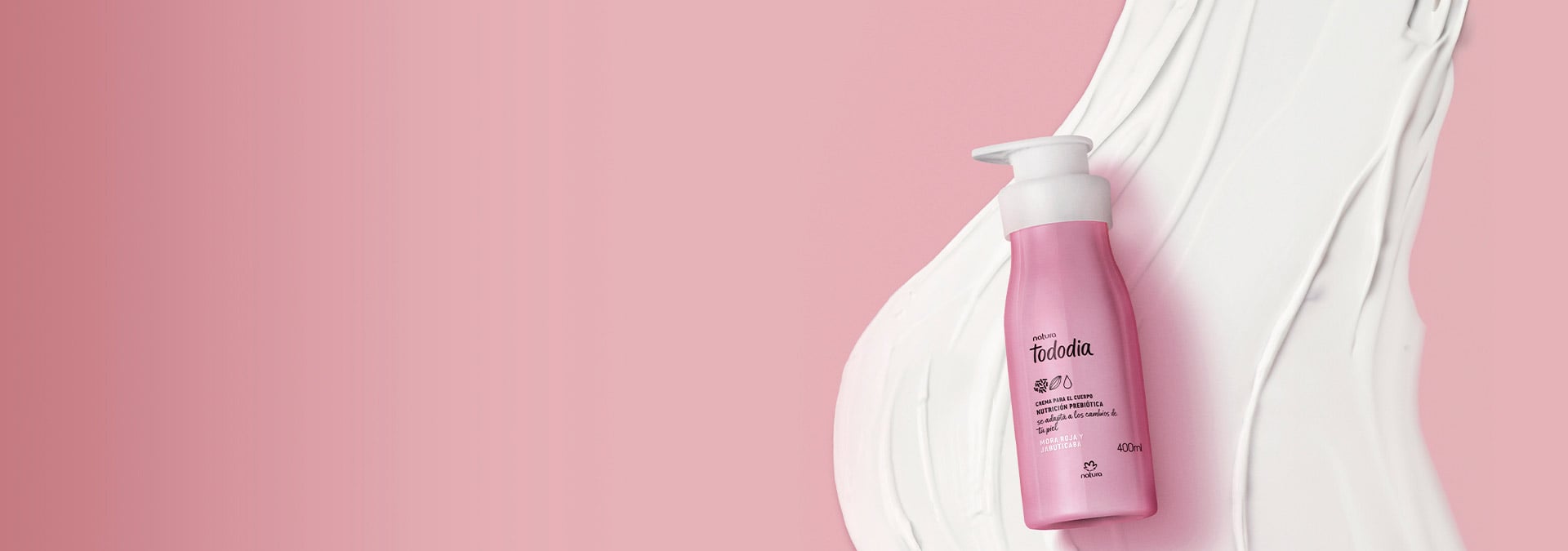 Fondo rosa con una crema hidratante corporal Tododia a la derecha, con la textura del producto detrás.