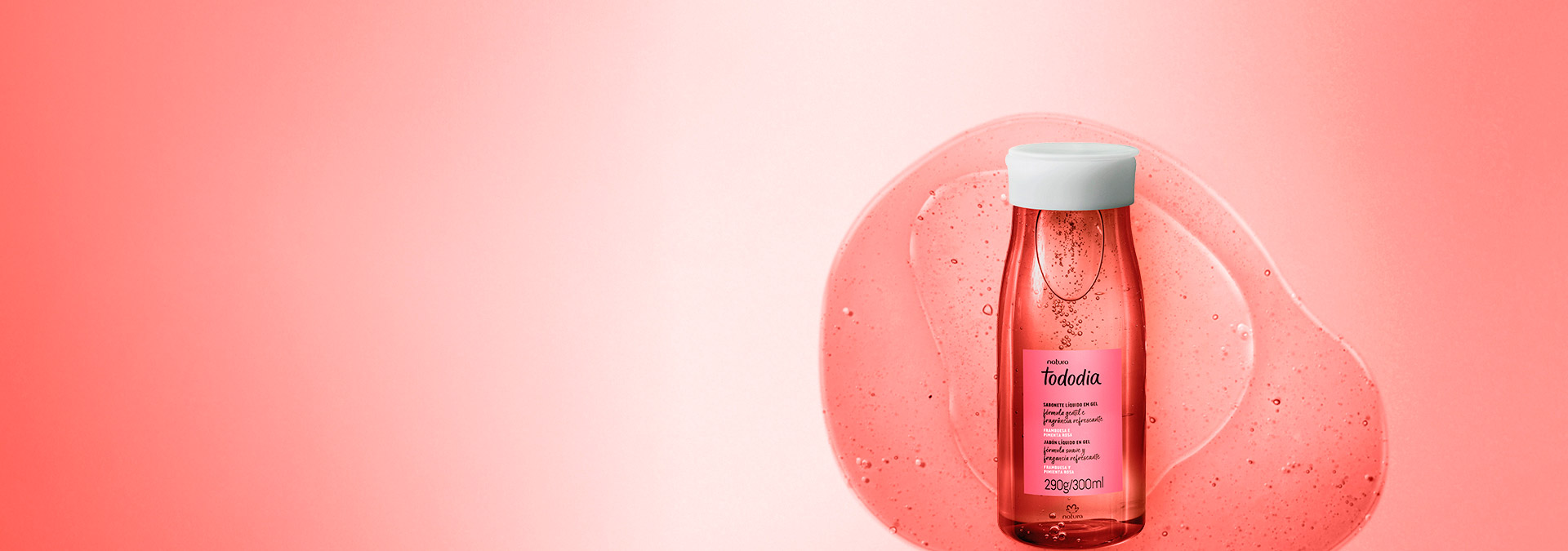 Fondo en tonos de rojo y a la derecha un frasco de jabón líquido Natura Tododia Frambuesa y Pimienta Rosa