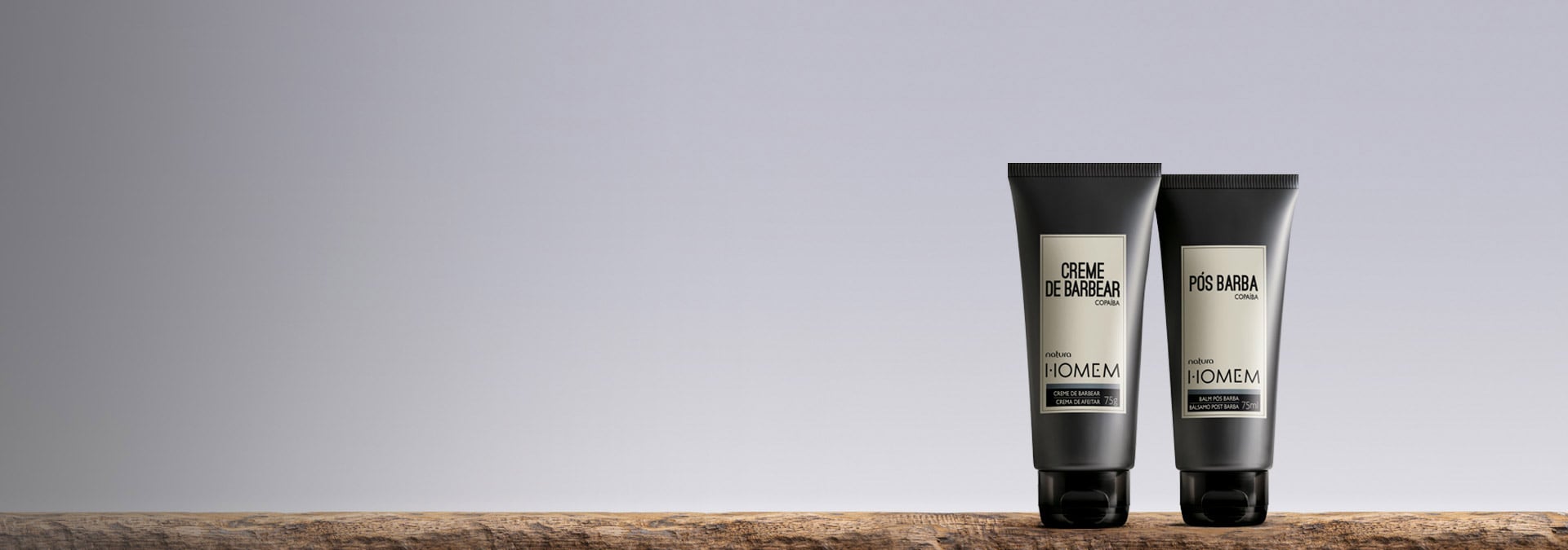 Fondo claro en tonos de gris con dos productos Natura Homem para afeitar en el lado derecho