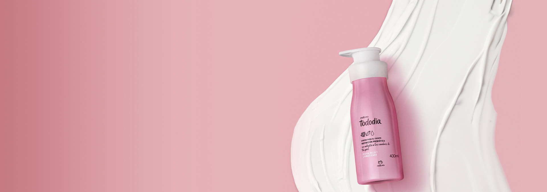 Fondo rosa con una crema hidratante corporal Tododia a la derecha, con la textura del producto detrás.