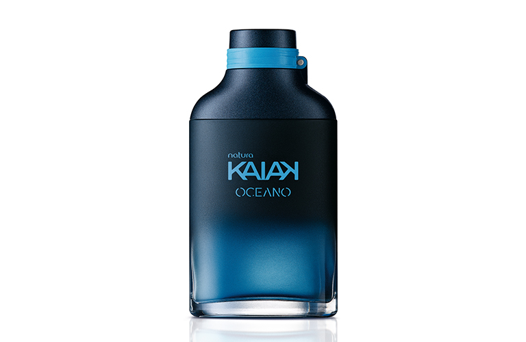 Sobre un fondo blanco, se presenta un frasco de perfume Kaiak Océano, con tonalidades que van del negro al azul.
