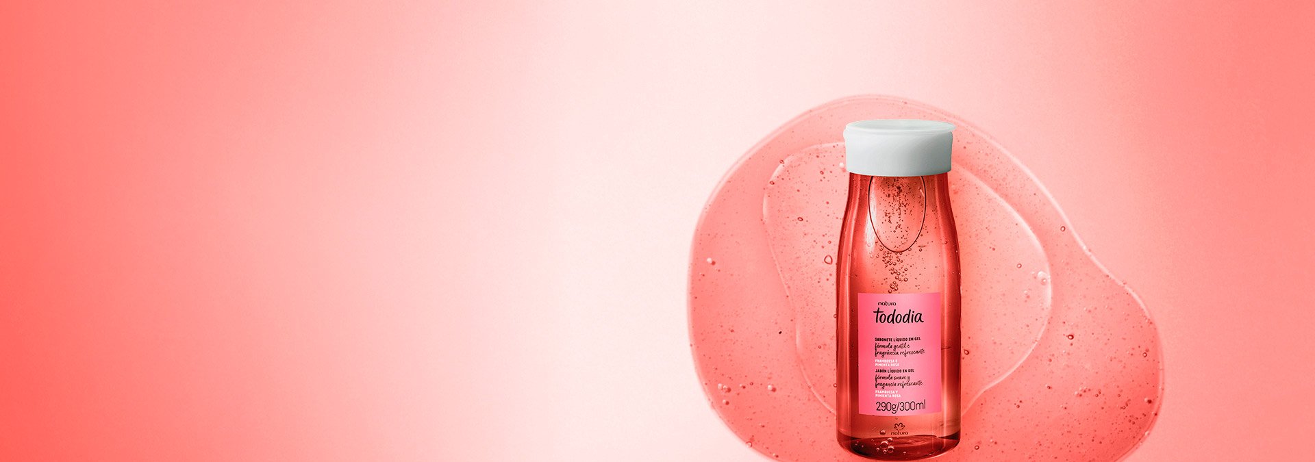 Fondo en tonos de rojo y a la derecha un frasco de jabón líquido Natura Tododia Frambuesa y Pimienta Rosa